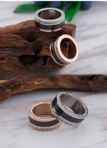 Detail of titanium steel ring with black carbon fiber inlay and double row of diamonds