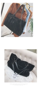 Detail of black faux fur tote bag with leather handles and silver metal chain strap