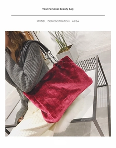 Burgundy faux fur tote bag detail showing the metal chain strap on a model's shoulder