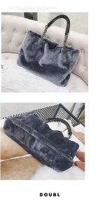 Detail of grey plush faux fur tote bag featuring leather handles and dark metal chains