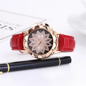 Close-up of red crocodile embossed leather strap and floral rhinestone watch dial