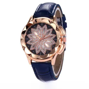 Detailed macro view of a rose gold watch featuring a diamond-set floral dial and blue strap