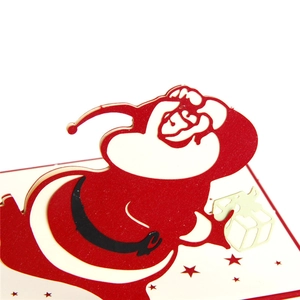 Creative 3D pop-up Christmas card featuring a detailed Santa Claus paper sculpture