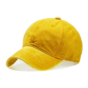 Detailed macro view of the washed cotton fabric texture and stitching on a yellow kids cap