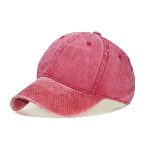 Close-up of washed cotton baseball cap texture in vintage red with six-panel design