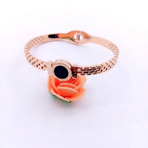 Detailed view of rose gold stainless steel bracelet with black disk and Roman numerals