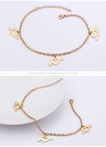 Detail of gold heart arrow anklet with adjustable extension chain on white ceramic plate