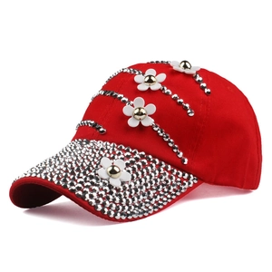 Red baseball cap with 3D white flowers and silver rhinestones shown at a 45-degree angle