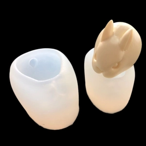 Detailed view of 3D rabbit silicone mold and a finished white mousse cake rabbit head
