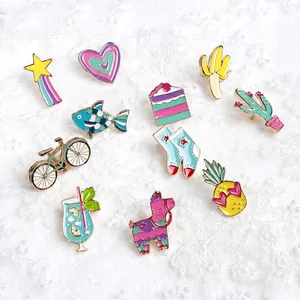 Set of 11 cute cartoon enamel pins including cactus and rainbow on a soft white background