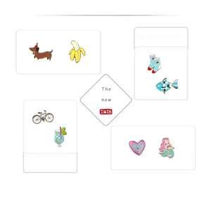 Detail of colorful enamel lapel pins featuring cartoon dog, mermaid and heart motifs