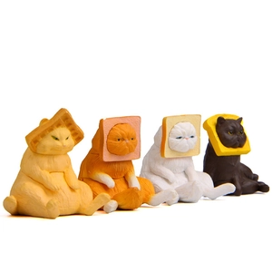 Detailed view of four miniature cat figurines wearing toast and waffle headwear