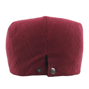 Deep red vintage cotton linen beret featuring textured fabric and back metal buckle detail