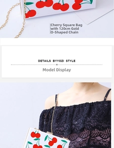 Detailed view of white acrylic clutch with cherry prints and golden metal chain