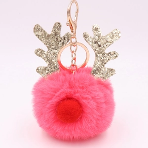 Pink plush reindeer keychain with gold glitter antlers and metallic keyring close-up