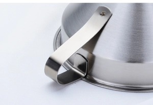 Macro shot of a durable stainless steel kitchen funnel with a sturdy riveted metal handle
