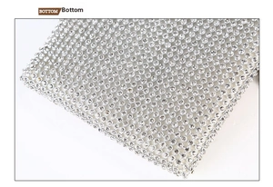 Close-up of sparkling silver rhinestones on the bottom of the crossbody chain evening bag