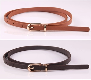 Detail of brown and coffee thin PU leather belts with golden metal pin buckles