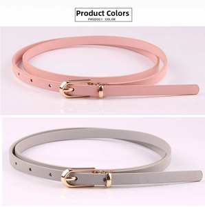 Detail of pink and grey thin PU leather belts with gold buckles and grain texture