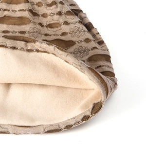Detail of warm winter knit beanie showing brown wavy texture and thick beige fleece lining