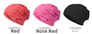 Detailed knit texture of red, magenta, and black slouchy beanies with hollow mesh design