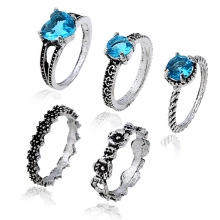 Five-piece silver alloy ring set featuring light blue heart stones and boho wave patterns