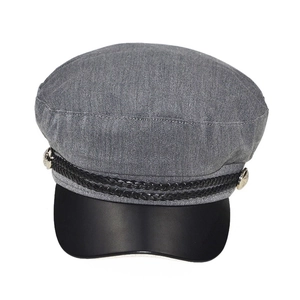 Detail of grey newsboy cap showing woven rope trim and metallic buttons on visor