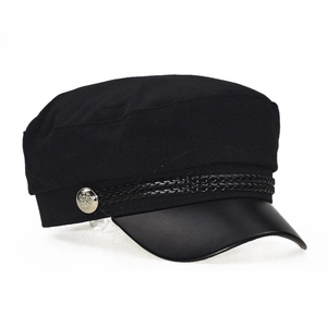 Close-up of black navy hat featuring leather brim and metallic button detail