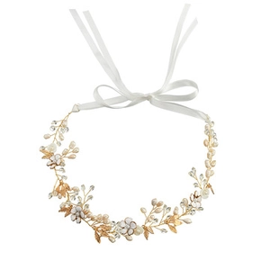 Detail of handmade gold metal bridal headband with white pearls and crystal flower motifs