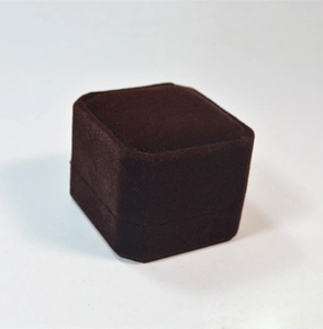 Macro shot of a closed square dark brown velvet jewelry box on white background