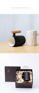Detail view of ceramic mugs with wooden handles and premium black gift packaging box