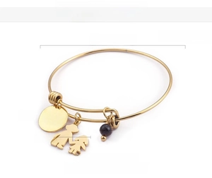 Macro shot of 18K gold plated bracelet with I Love You Mom pendant and charms