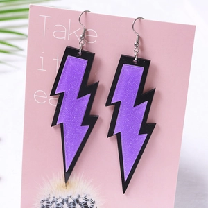 Fashionable acrylic lightning bolt earrings with purple glitter inlay on a pink display card