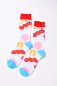 Detailed view of white cotton socks with colorful abstract patterns and red ribbed cuffs