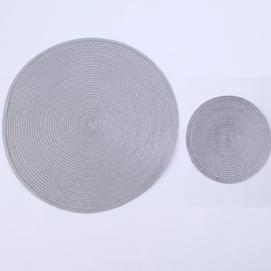 Detail of round grey woven place mats with concentric texture for kitchen and dining