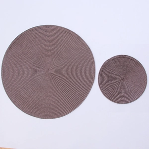 Detail of round woven brown place mat and coaster with heat resistant texture