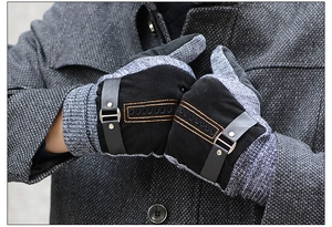 Detail of men's black leather and grey knit gloves with adjustable buckle strap