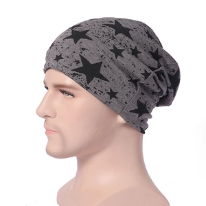 Détail du bonnet en maille gris avec motif étoile noire porté par un modèle homme