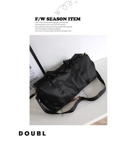 Detail of waterproof nylon gym bag with reinforced handles and removable shoulder strap
