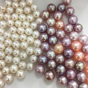 Top view of assorted natural freshwater pearls in white pink and purple shades