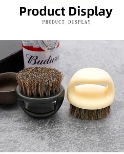 Close-up of portable beard brushes with round ergonomic handles and dense natural bristles