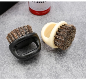 Detail view of black and beige finger ring brushes with natural boar bristles for beard grooming