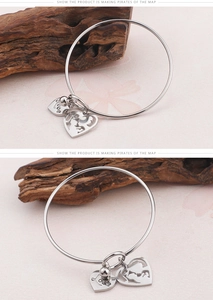 Detail of silver titanium steel bracelet with Love heart and mother-child charms