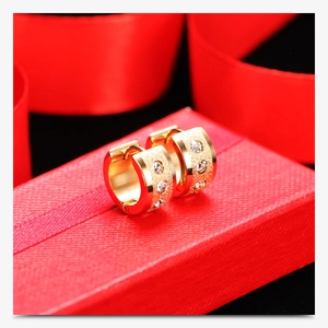 Detail of 18K gold-plated frosted hoop earrings with three inlaid sparkling zircon stones