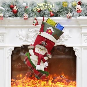 Christmas stocking with snowman doll hanging on fireplace mantel with warm holiday decor
