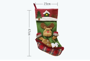 Detailed view of green felt Christmas stocking with reindeer plush and size dimensions