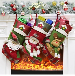 Detailed view of Christmas stockings with Santa, snowman and reindeer hanging by the fireplace