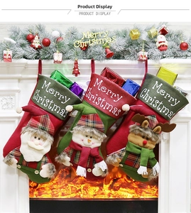 Three Christmas stockings with 3D Santa, Snowman and Reindeer hanging by a fireplace