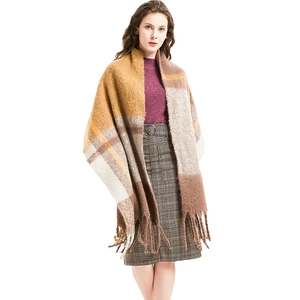 Thick plaid tassel scarf in brown and beige colors, styled on a model for winter wear