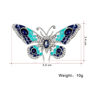 Detail view of butterfly brooch showing 5.0cm width, enamel wings and rhinestone trim